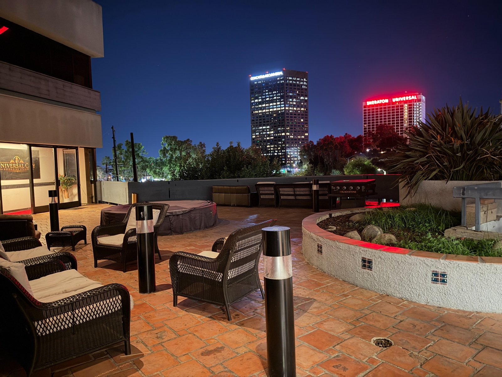 Outdoor studio patio with lounge seating and nighttime city views