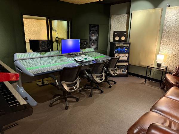 Recording control room with a large-format mixing console and studio monitors