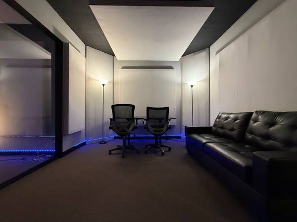 Private treated studio suite with lounge seating and acoustic panels